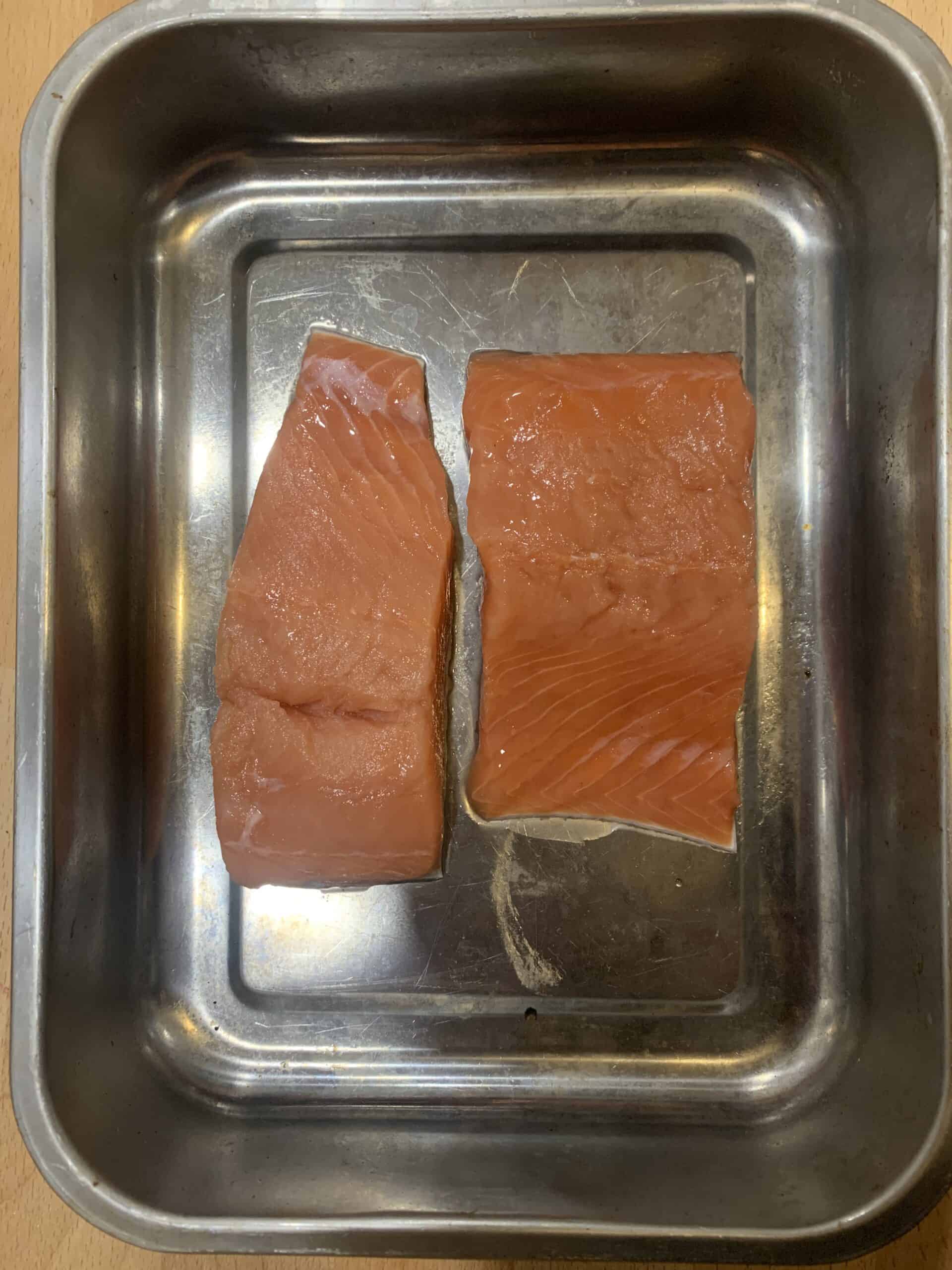 Photo of salmon fillets in a baking sheet