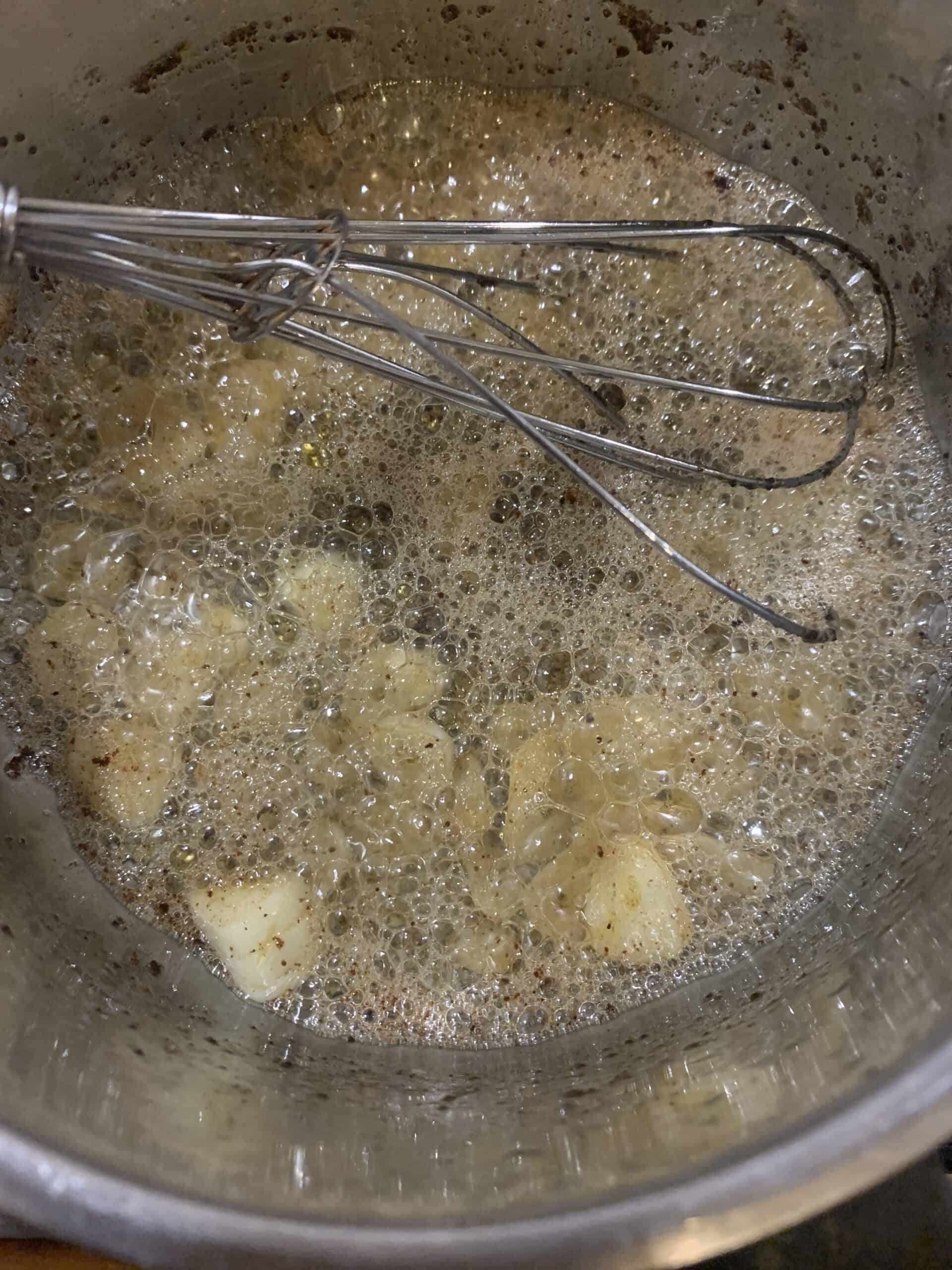 Butter and garlic in a sauce pan with a whisk