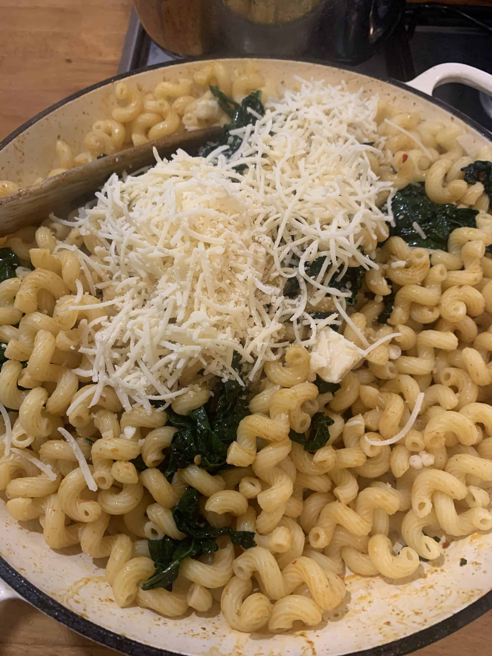 Pasta, cheese and kale in a pan