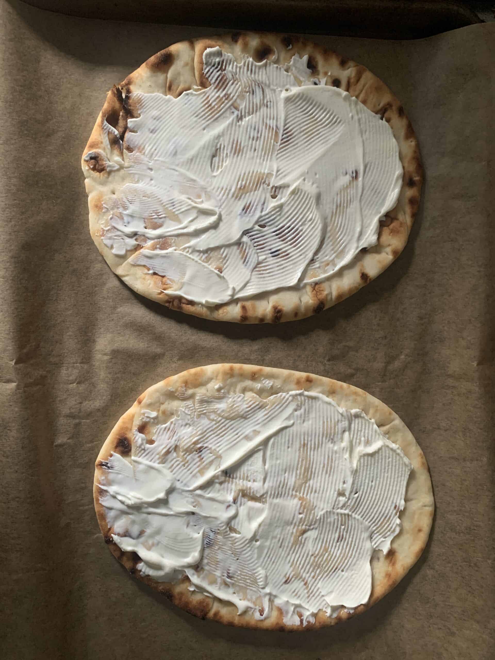 Overhead photo of flatbreads spread with cream cheese