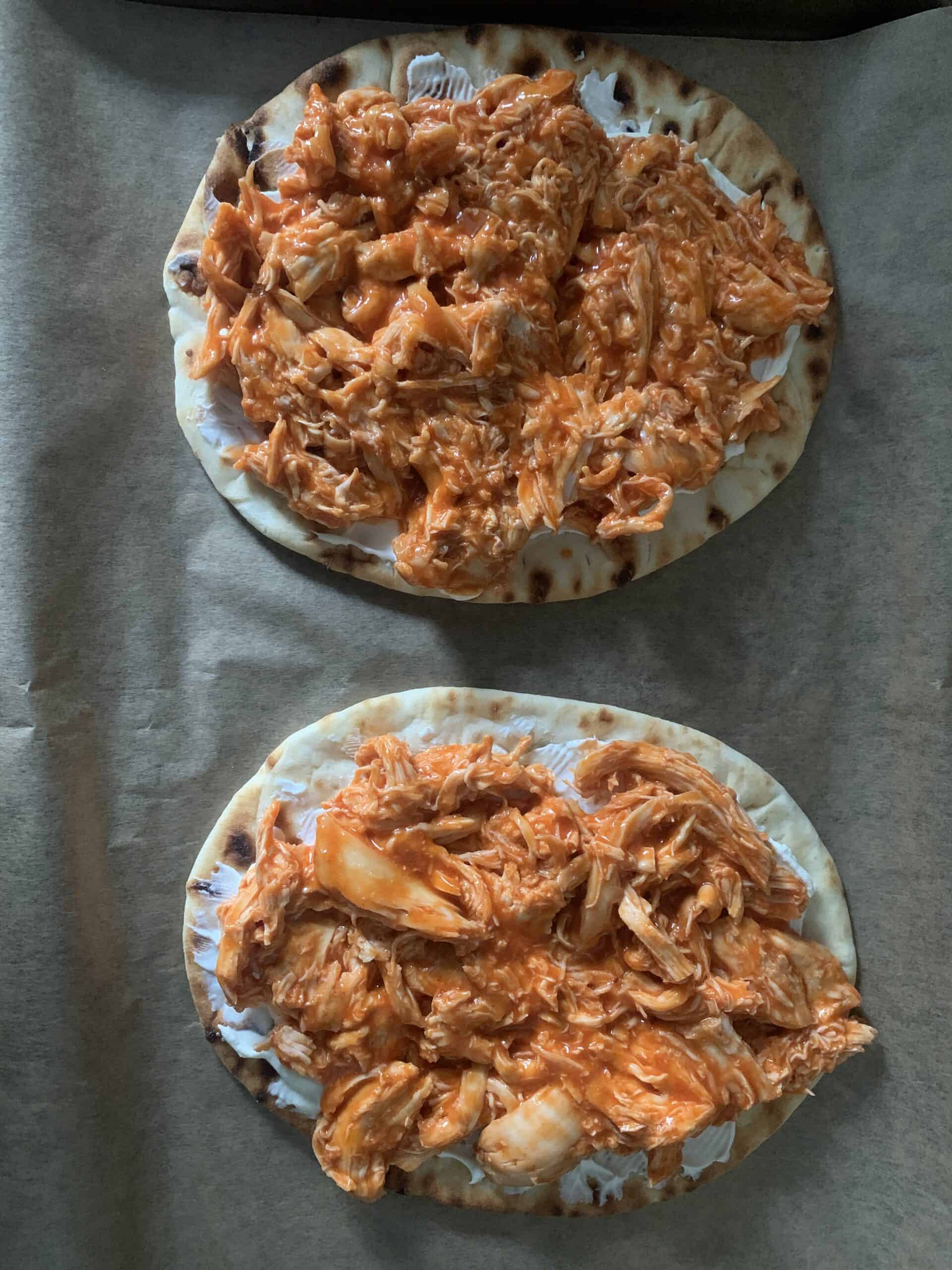 Two flatbreads topped with buffalo chicken