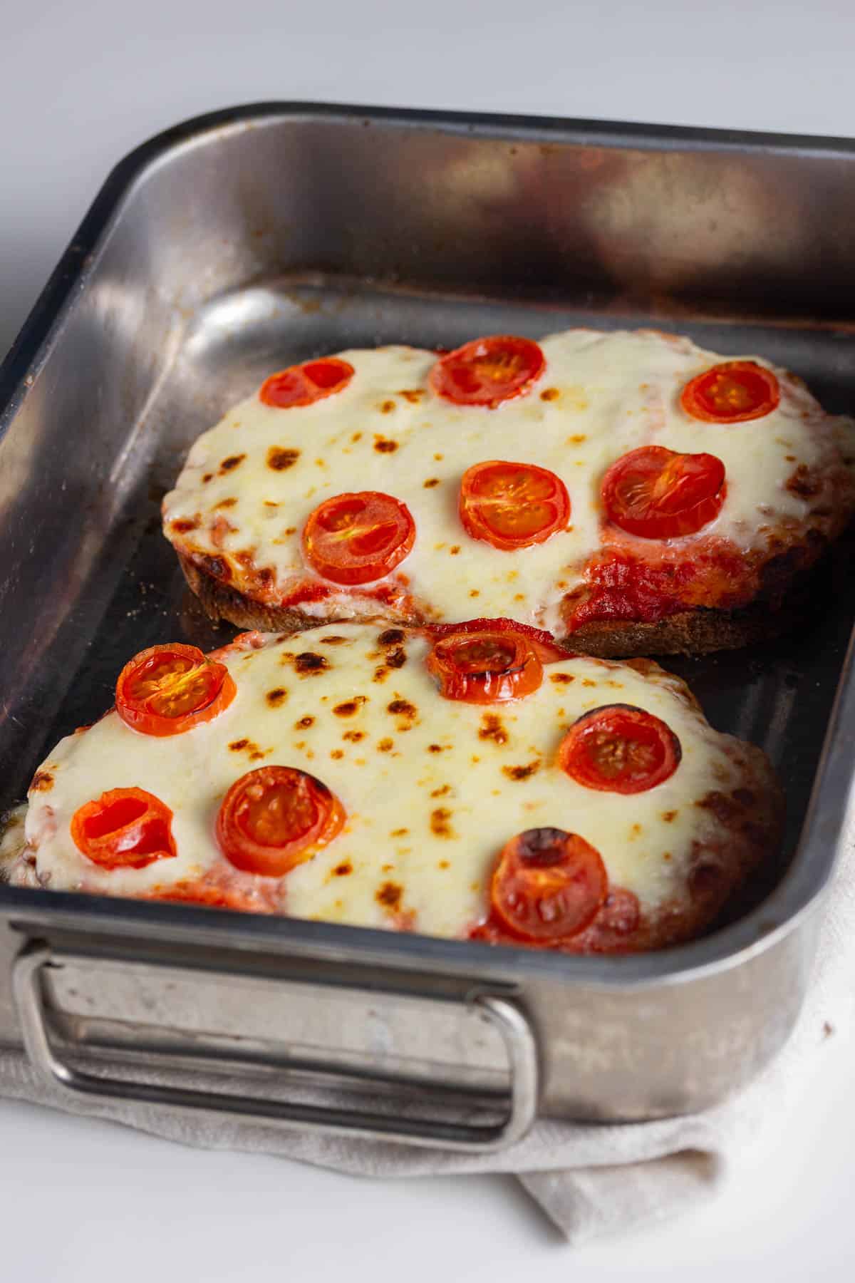 Silver tray of cooked pizza toasts