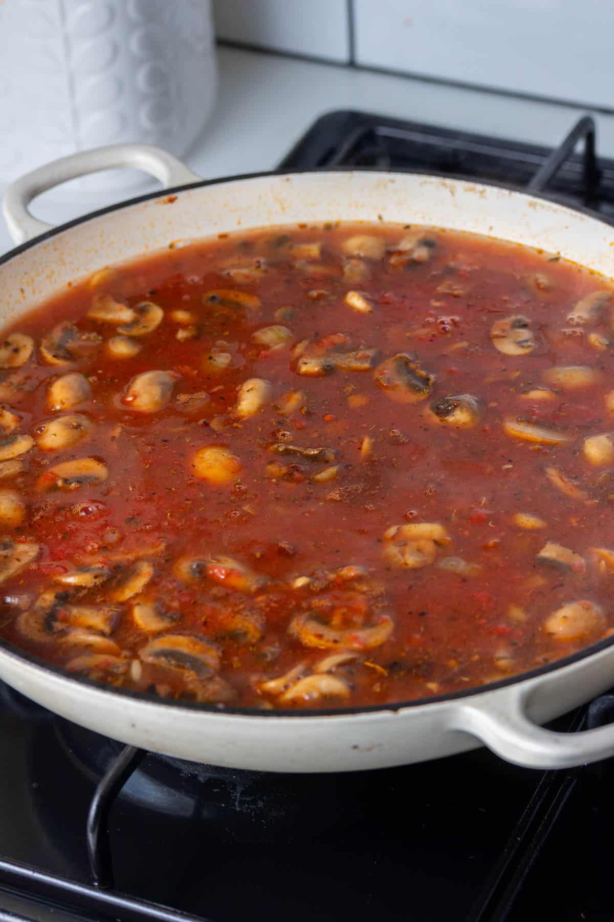 Tomato sauce with mushrooms in a pan