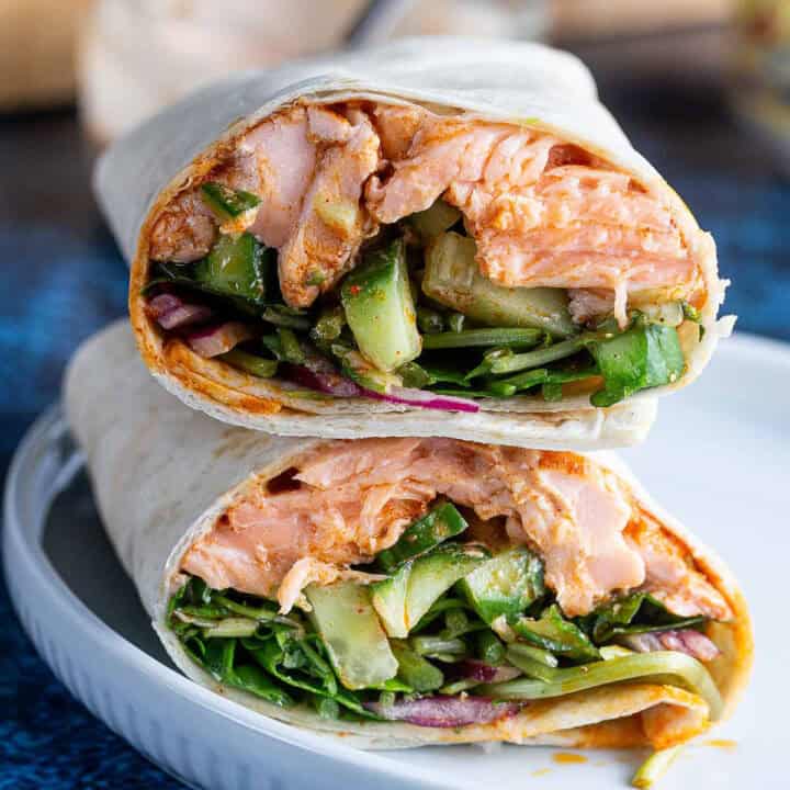 Salmon wraps piled on a blue plate
