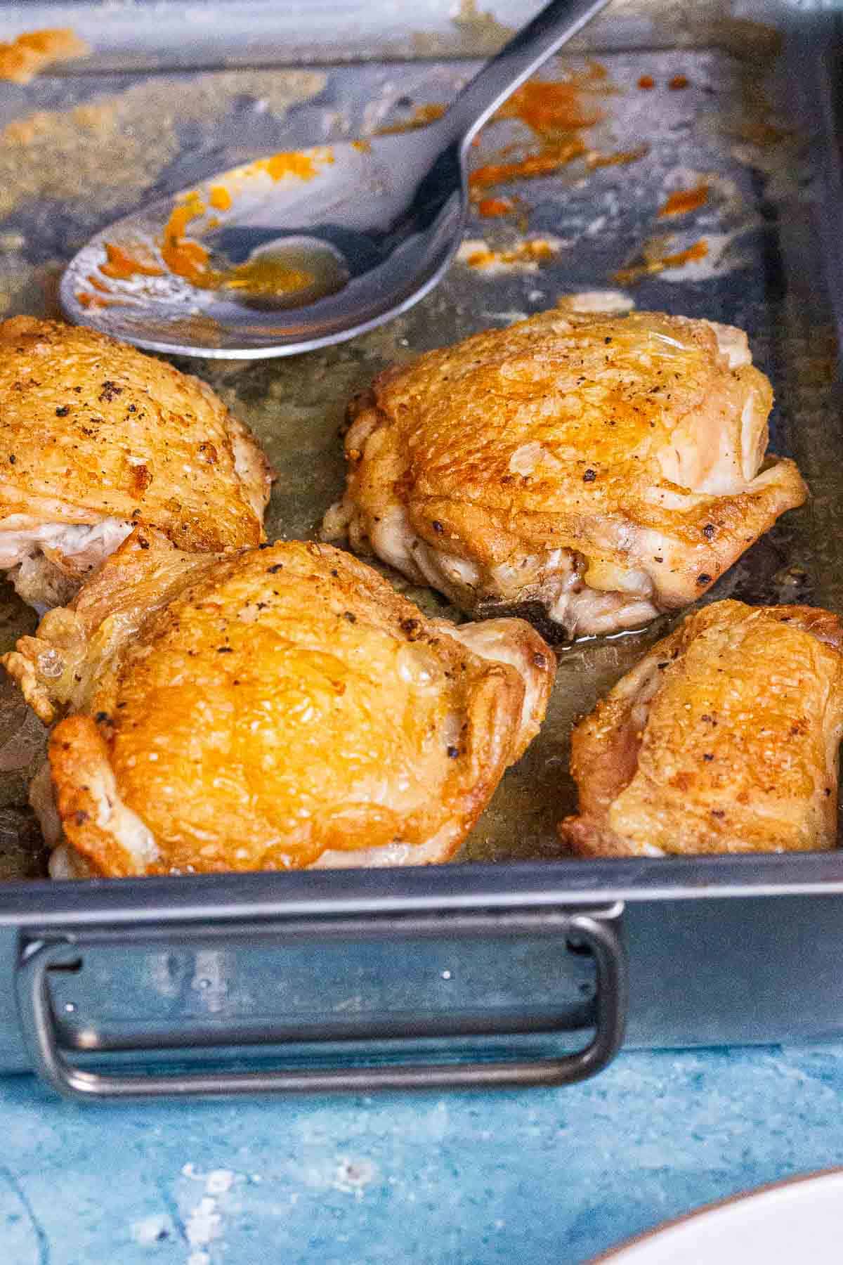 Crispy chicken thighs in a baking tray